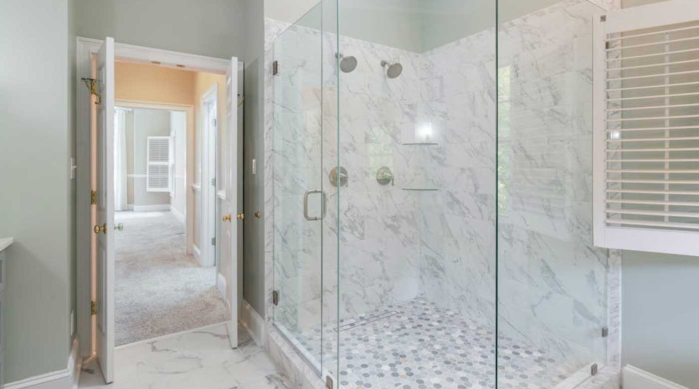An elegant look of a washroom with a glass shower door.
