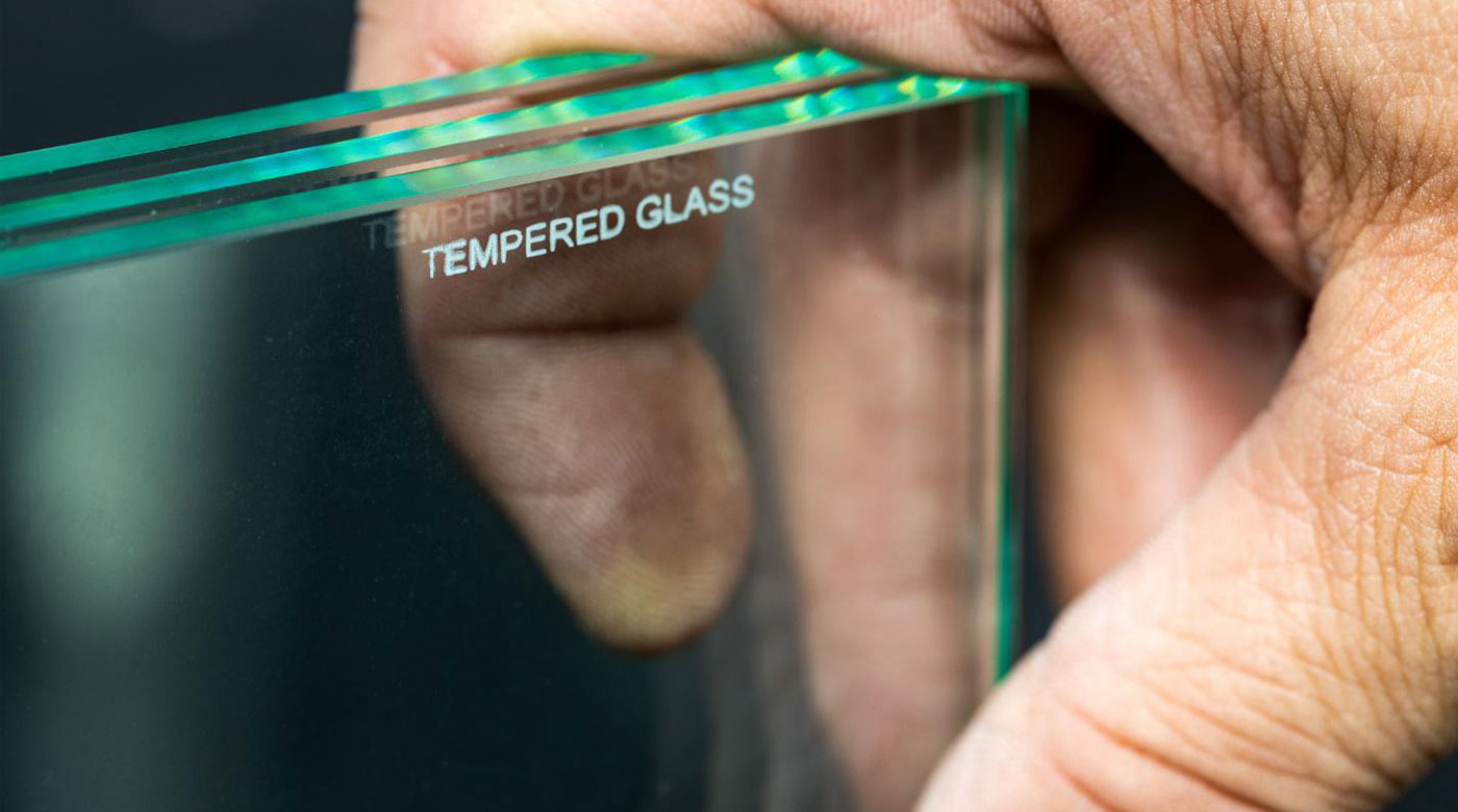A man holds tempered glass