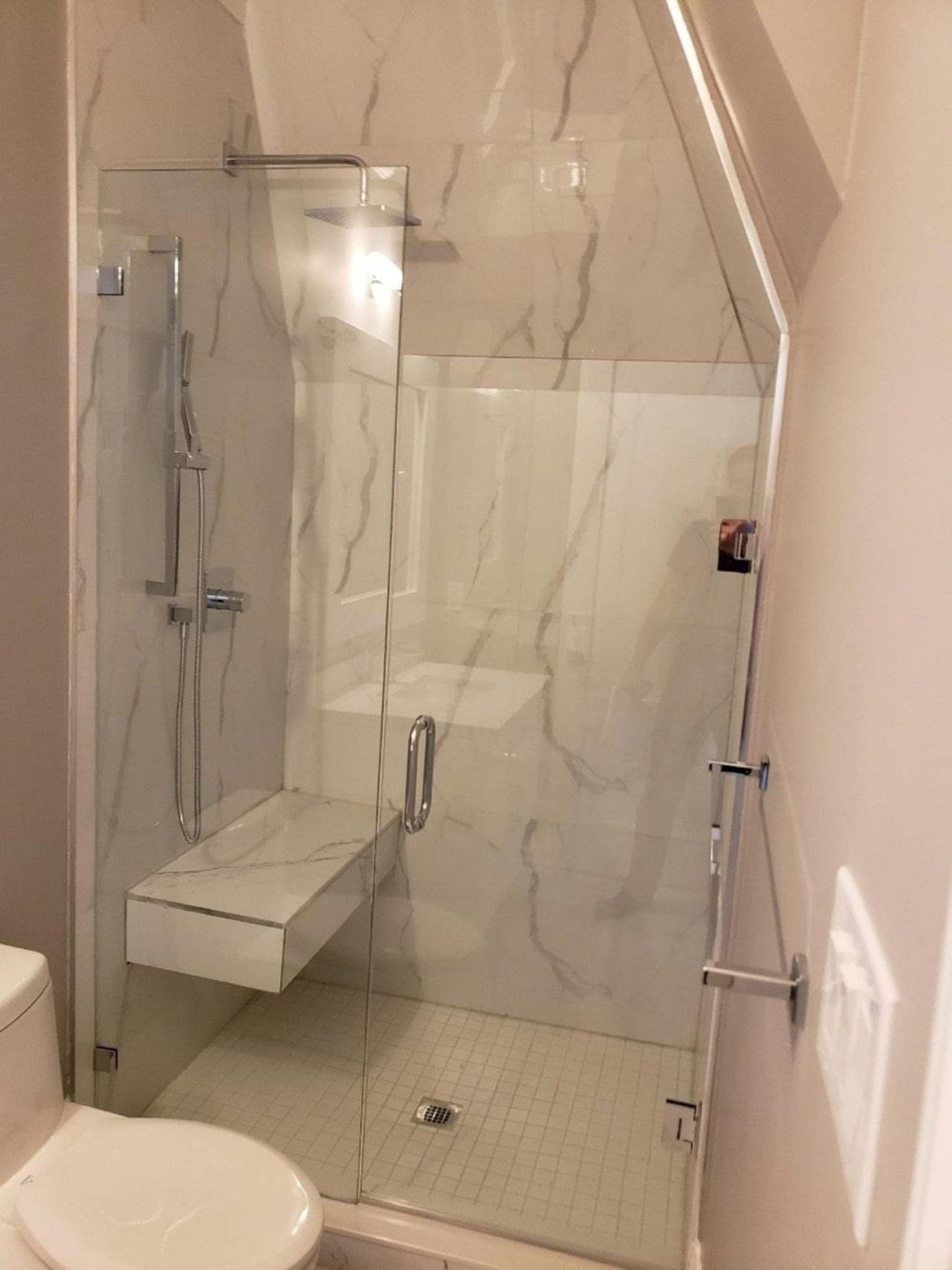 Modern frameless shower glass in a luxury bathroom.