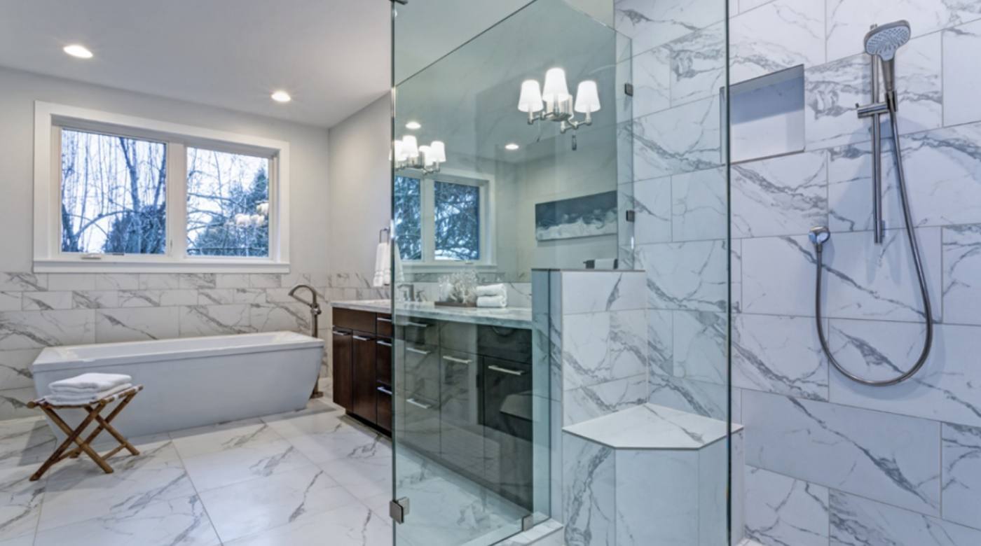 A frameless glass shower enhances the beauty of a washroom.