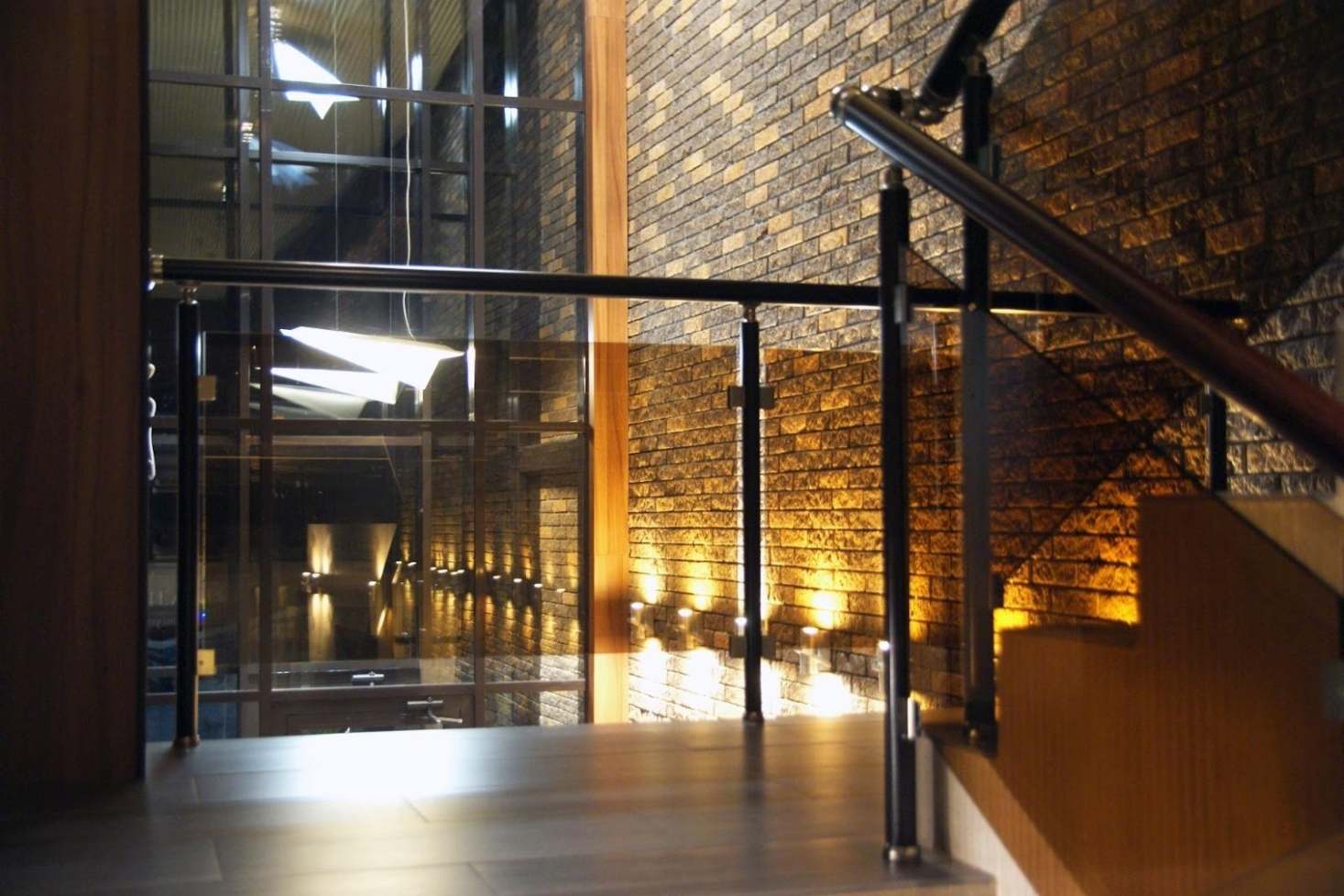 Glass staircase railing in a modern hotel interior.